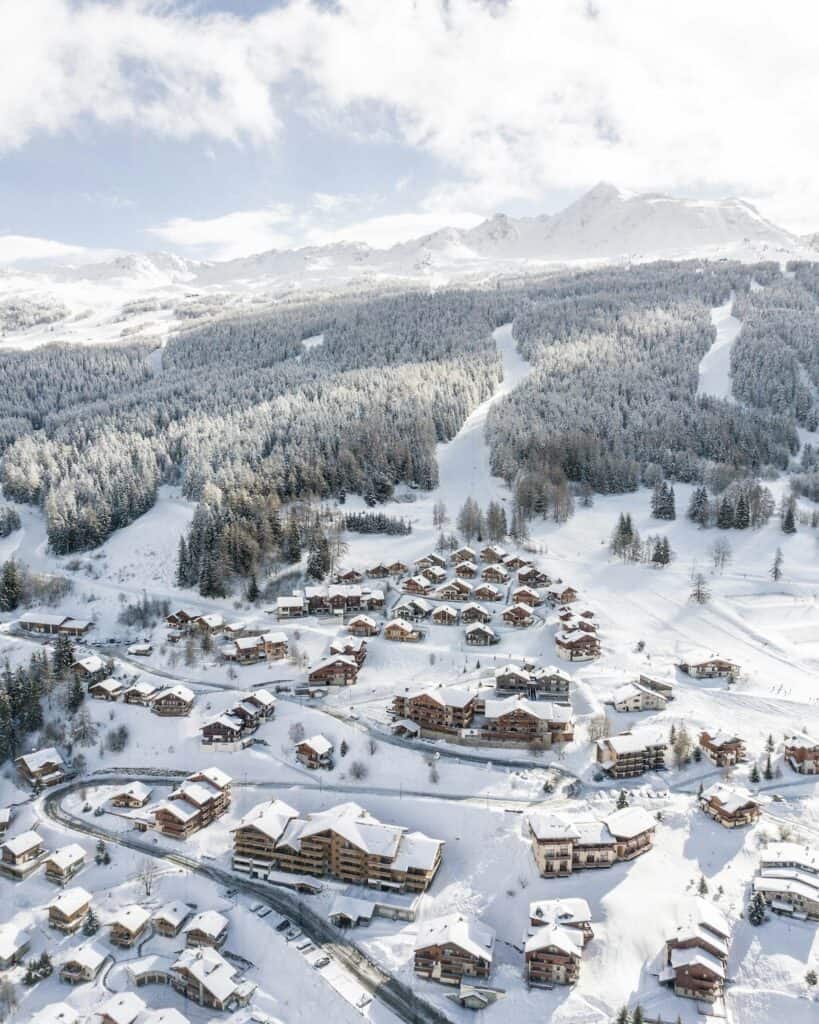 An aerial view of a ski town with ski slopes.