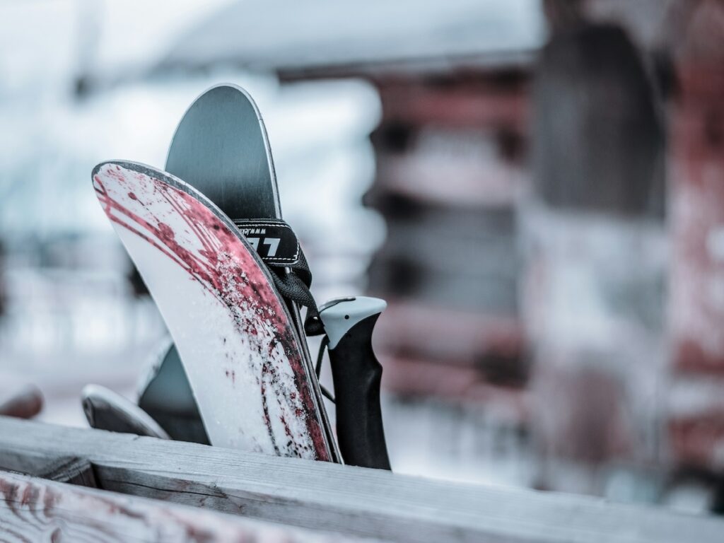 Skis leaned up against wood.