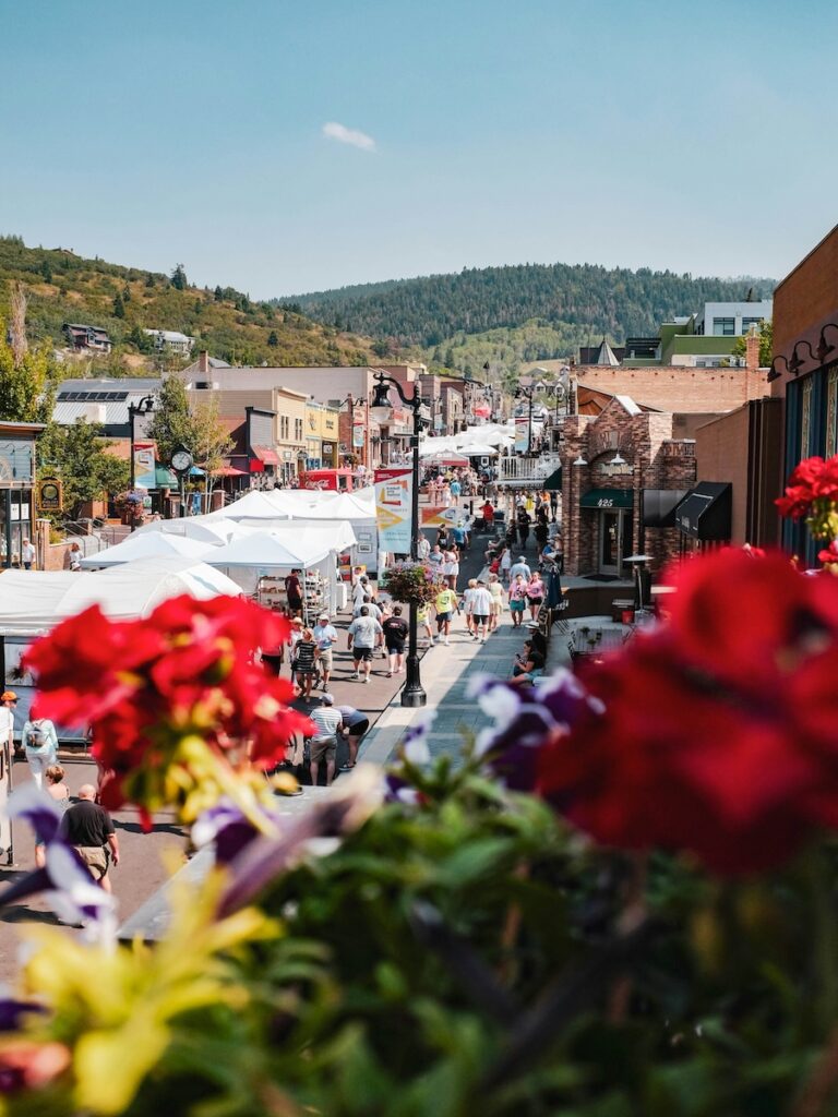 Park City during the summer with sunny skies and many people wandering around its famous downtown.