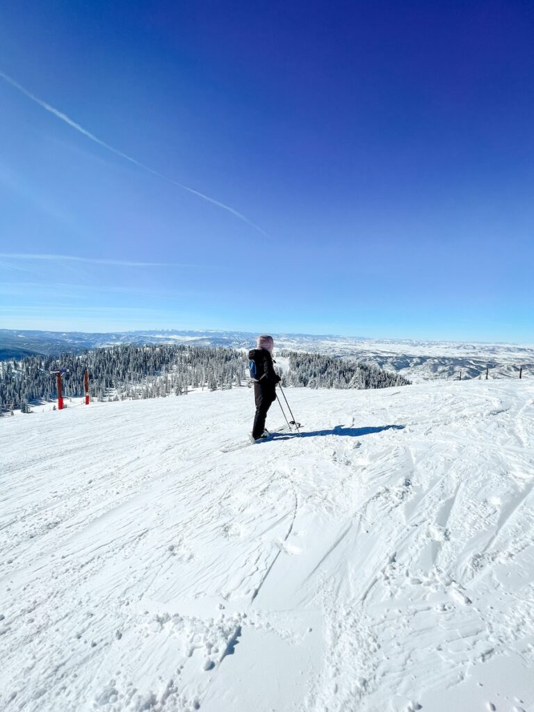 Abby skiing in Steamboat Springs on a bluebird day.