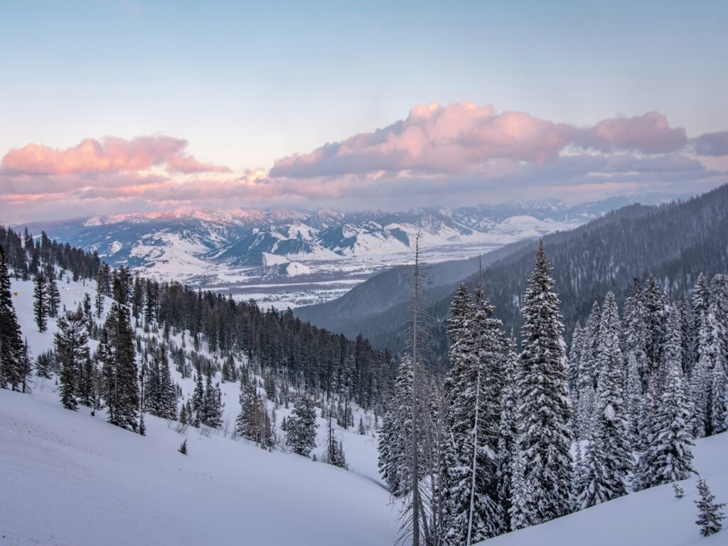 Jackson Hole Ski Resort as the sun begins to set and the sky turns blue, pink, and purple.