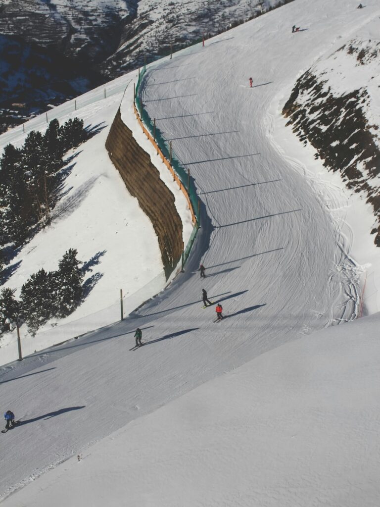A group of skiers going down a catwalk.