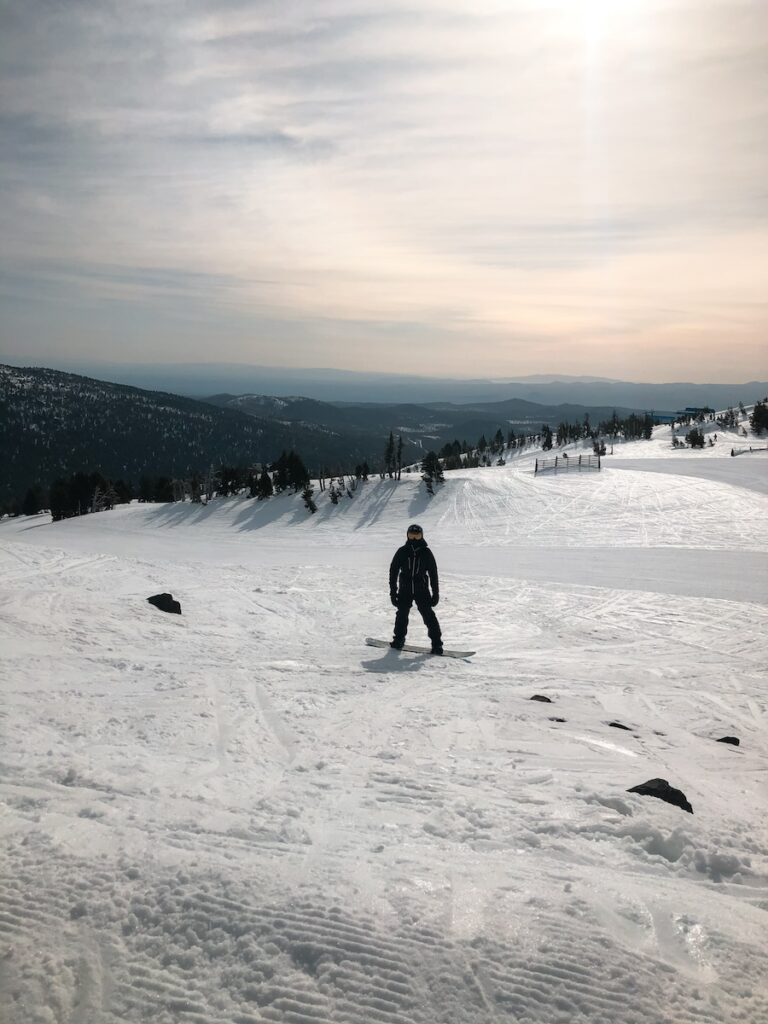 Sam standing with his snowboard on at Mt Bachelor.