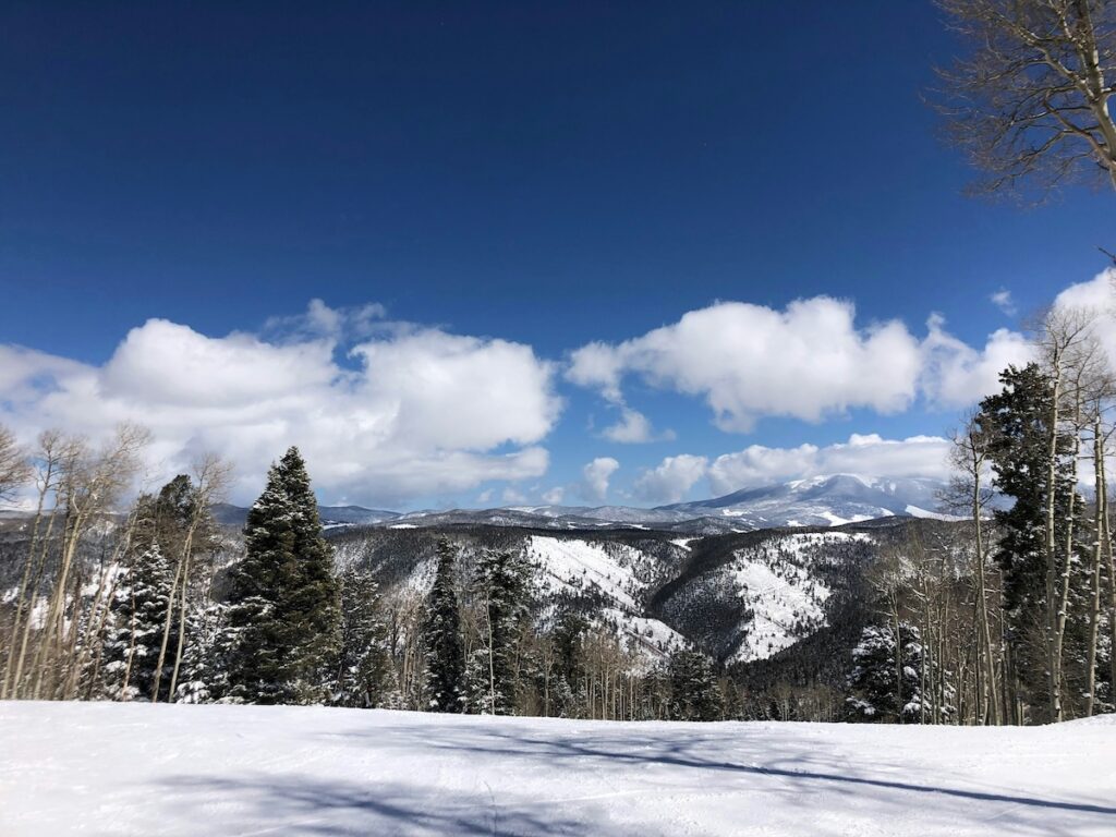 Snow covered mountains during one of the best times to ski at Taos.