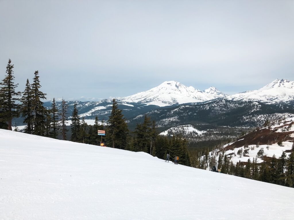 Ski slopes from the top of Mount Bachelor looking out at different mountain peaks.
