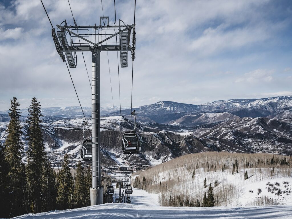The Snowmass Gondola with mountains in the background.