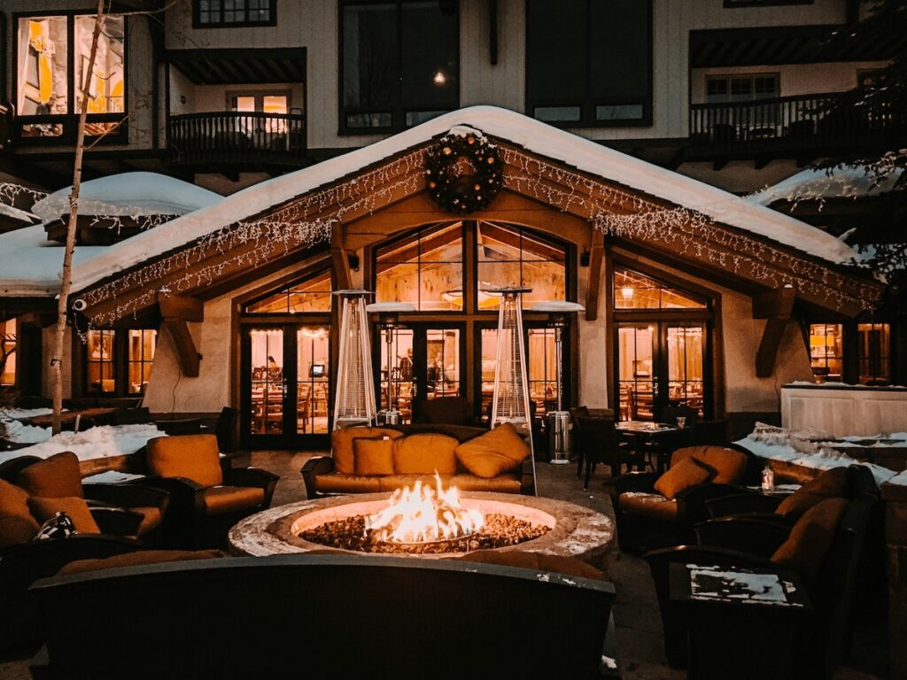 Vail Village at night with a fire pit glowing outside. 