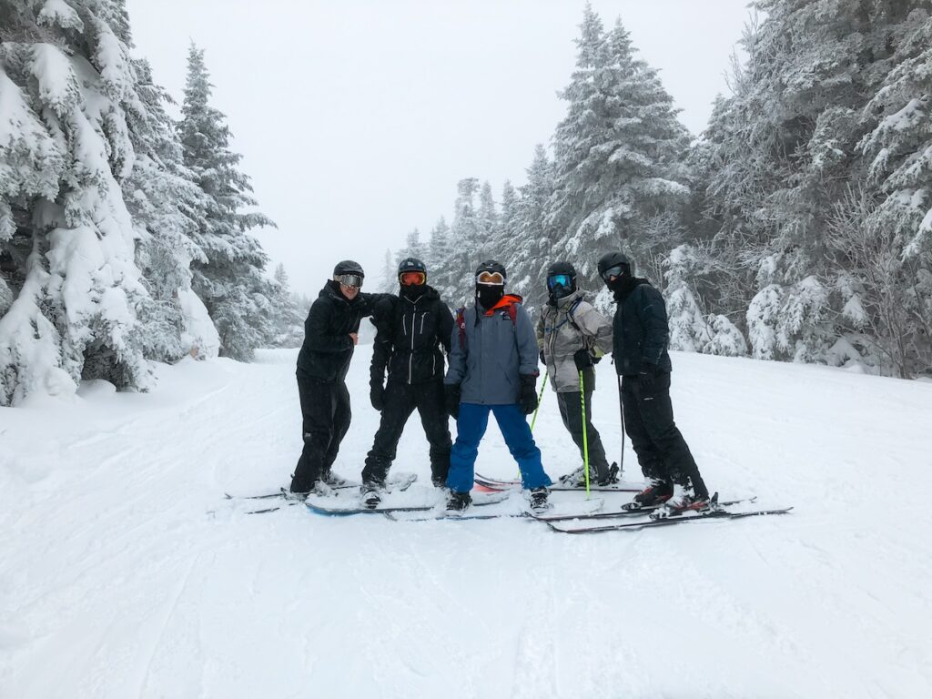 A group of skiers and snowboarders on the slopes in Vermont.