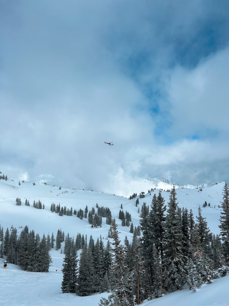 A helicopter flying over the ski resorts in Utah.