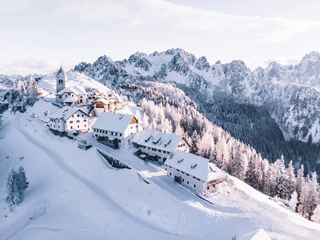 A couple of Ski In Ski Out condos with large mountains in the distance.