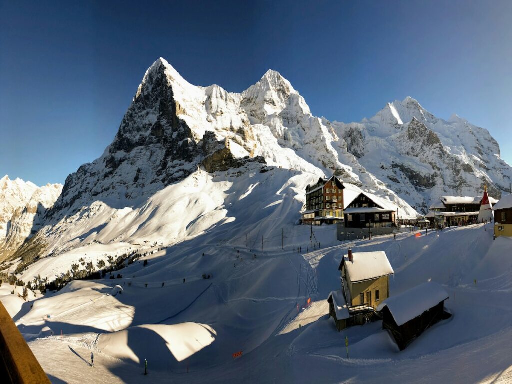 Ski In Ski Out accommodations right on the ski slopes with mountains in the background.