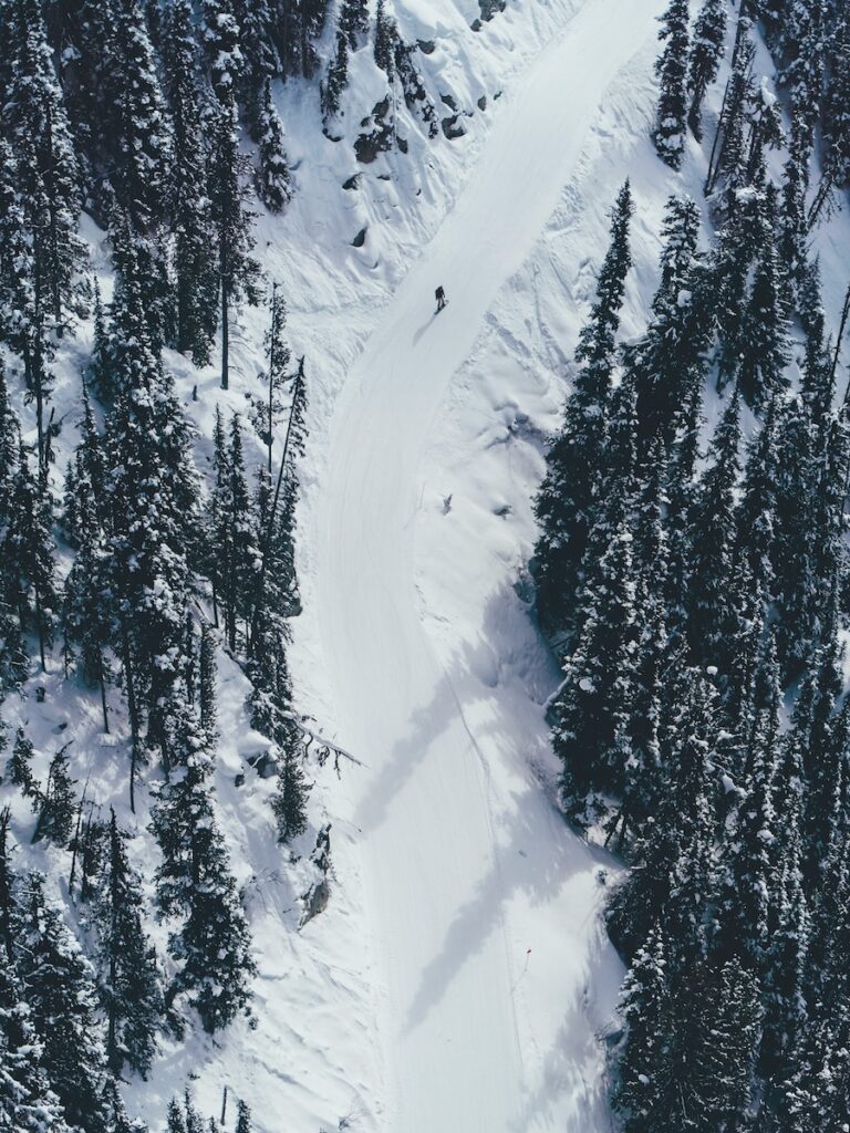 A snowboarder gliding down a groomed catwalk in the PNW.