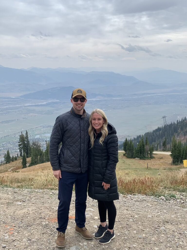 Abby and Sam smiling on top of Jackson Hole Mountain Resort. 