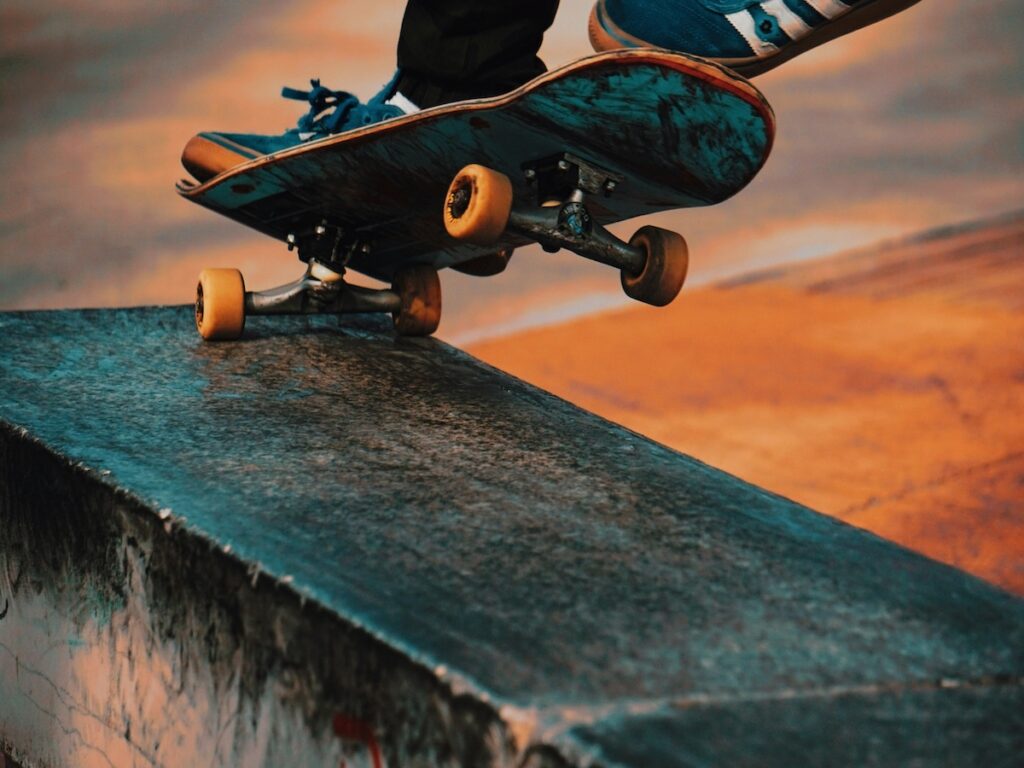 A skateboarder going down a ramp.