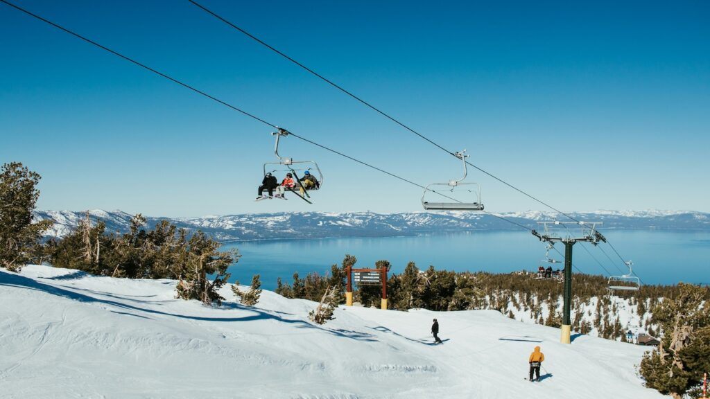 Skiers cruising by on a chair lift at Heavenly.