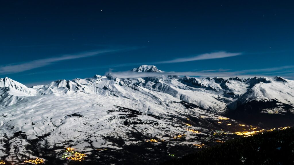 La Plagne, France at night with the town glowing with lights.