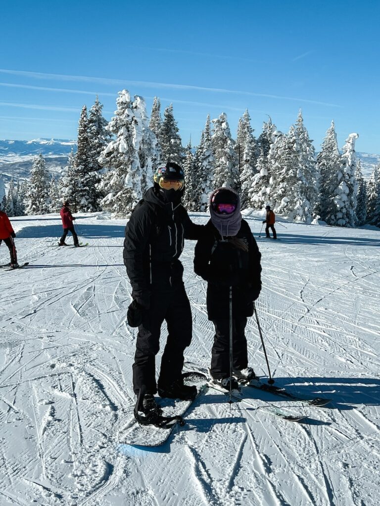 Abby and Sam skiing and snowboarding in Colorado on a bluebird day.