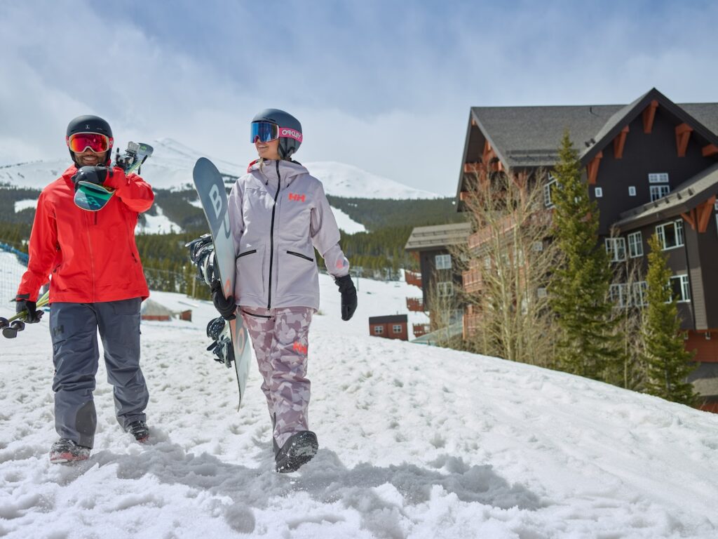 A skier and a snowboarder leaving one of the best ski in ski out Breckenridge accommodations to hit the slopes.