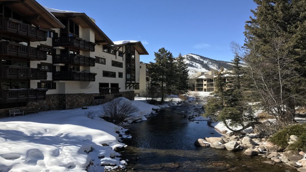 Vail Village surrounded by snow and blue skies.