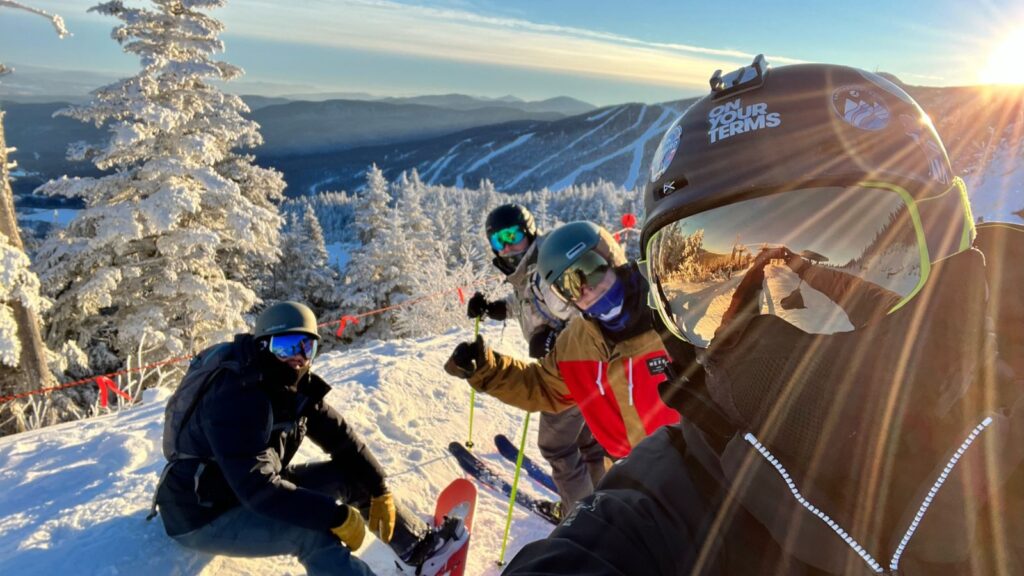 A group of friends skiing and snowboarding in Vermont.