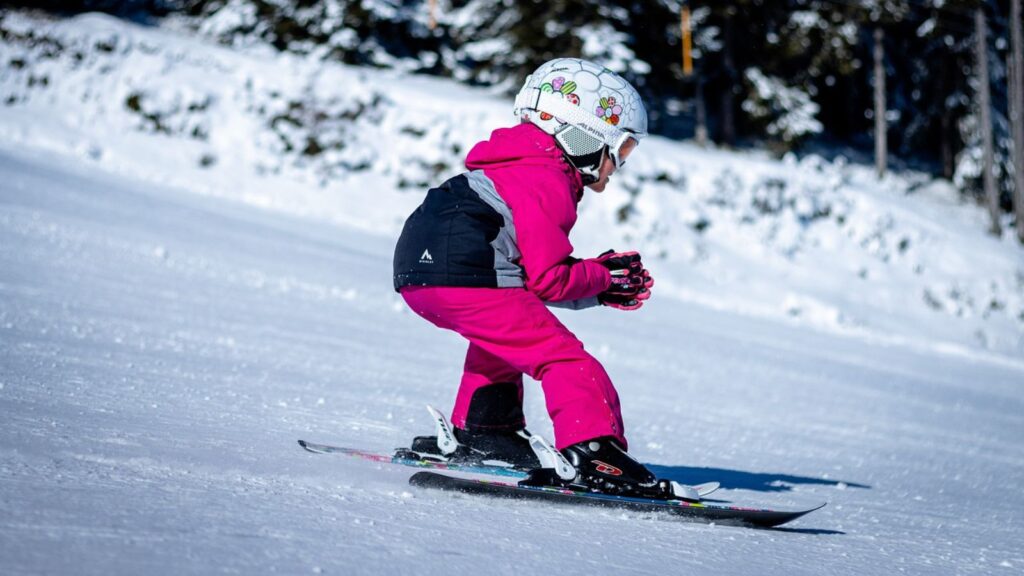 A child skiing in pink.