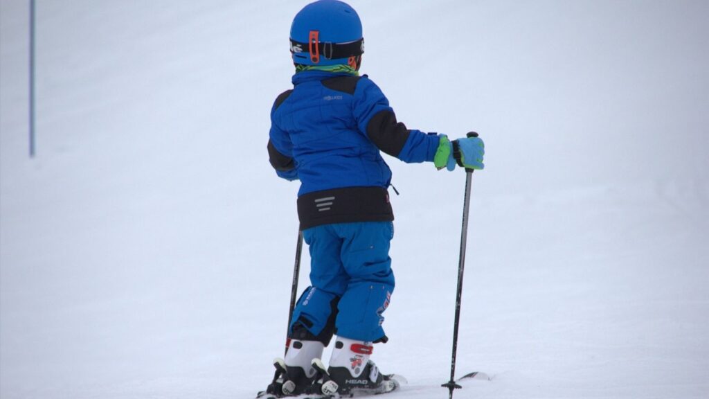 A child skiing in all blue.