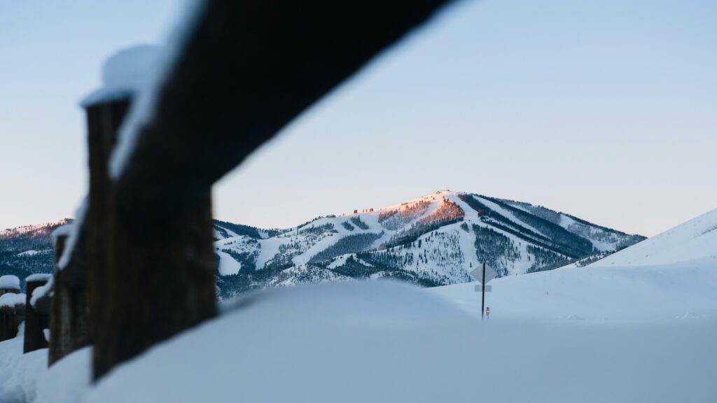 Ski slopes in Idaho through a fence.