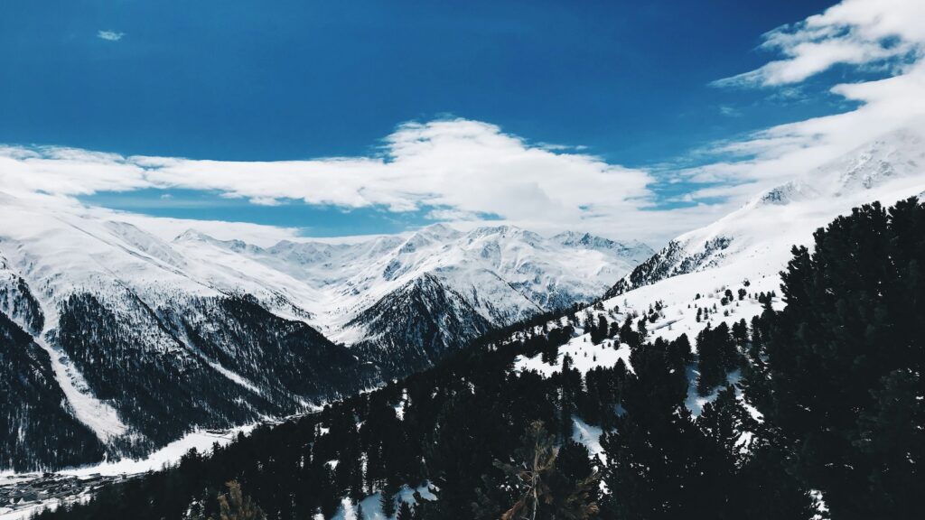 Snow covered mountains surrounded by trees in Livigno.