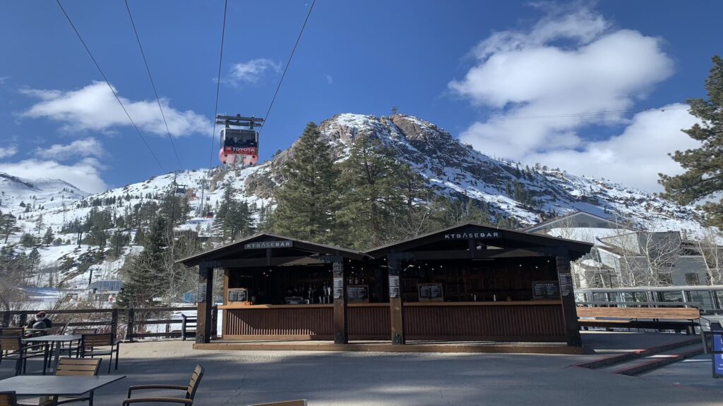 A gondola passing over a bar at Palisades Tahoe.