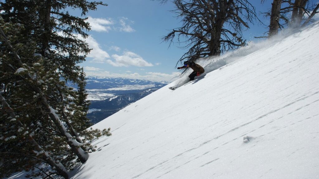 A skier going fast down a slope in Jackson Hole.