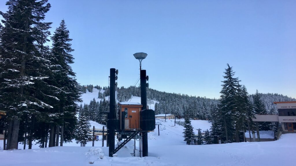 Stevens Pass ski area filled with snow on a blue sky day.