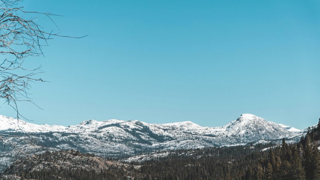 Snow covered mountains on a blue sky day in Lake Tahoe.