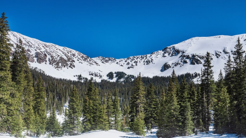 Blue skies above Taos Ski Valley in the winter.