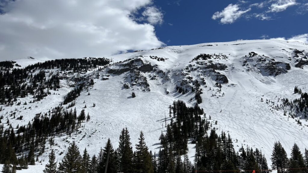 Ski and snowboard tracks going down the mountain at Telluride.