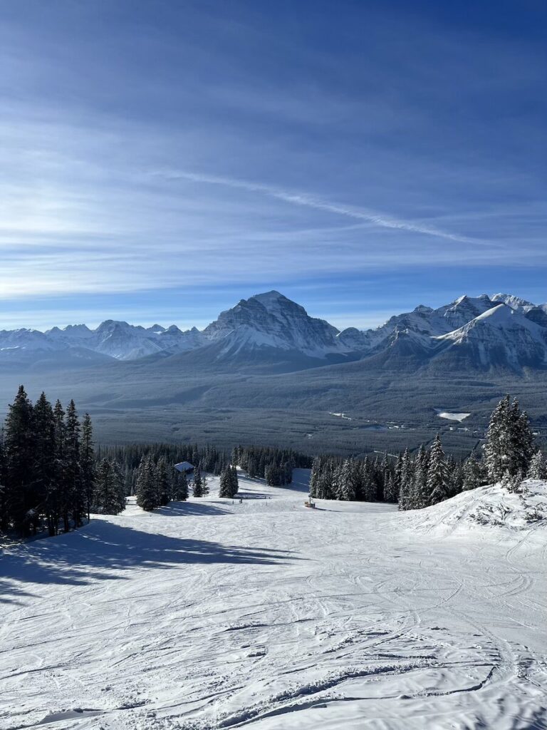 Ski slopes in Banff with huge mountains in the distance.