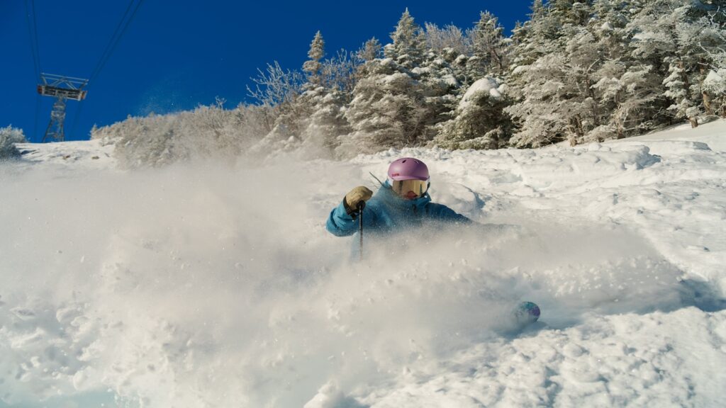 A skier going fast at Cannon Mountain.