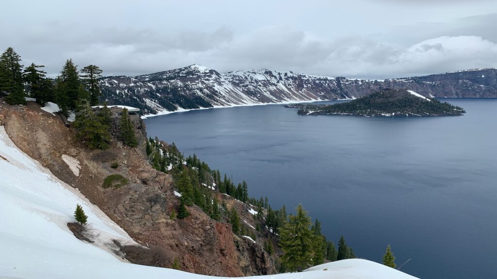 The rim at Crater Lake dotted in snow.