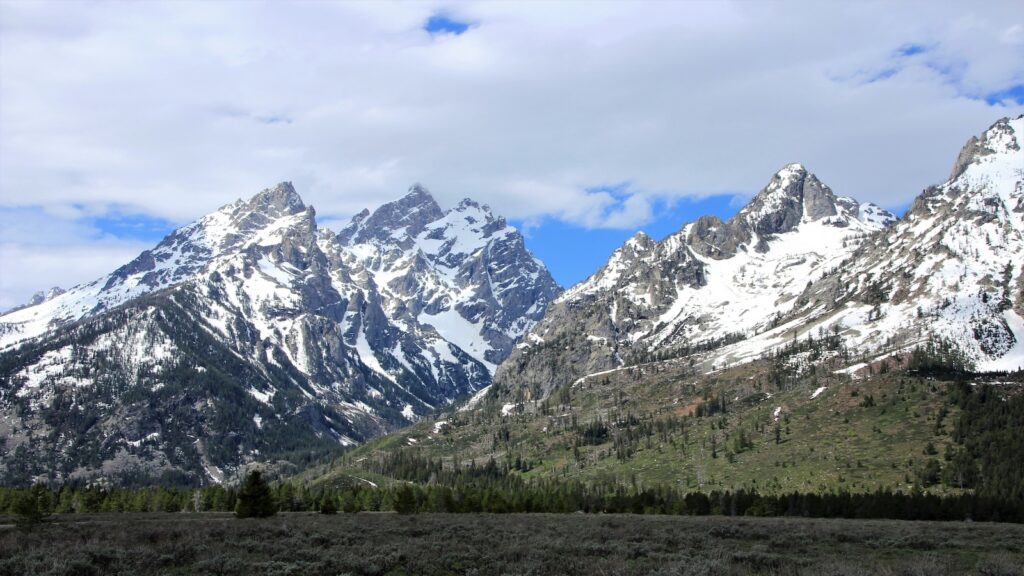 The Grand Tetons covered in some snow.