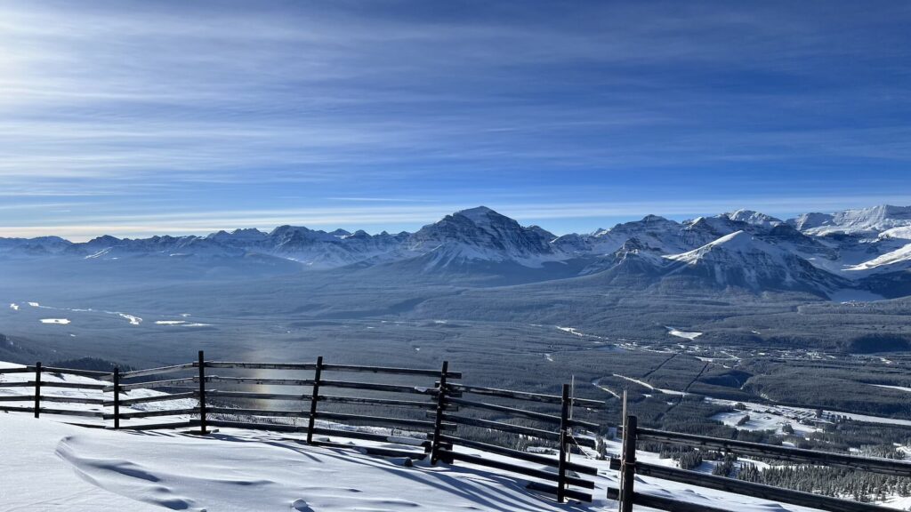 Views of the mountains and a fence at Lake Louise Ski Resort.