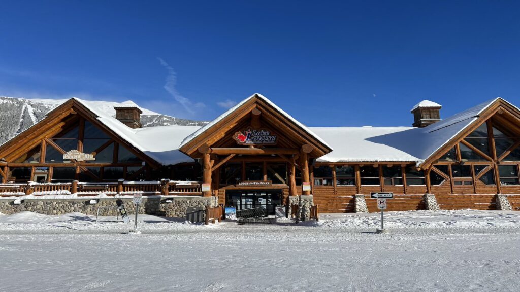 The lodge at Lake Louise with blue skies up above.