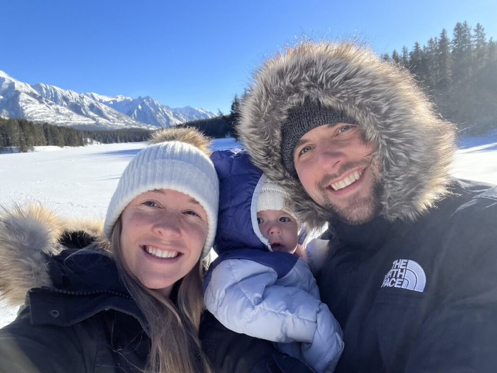 Price family smiling in Banff with snow surrounding them.