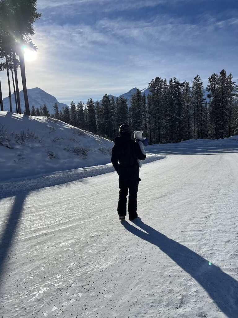 Sam and Daisy walking at a ski resort in Banff.