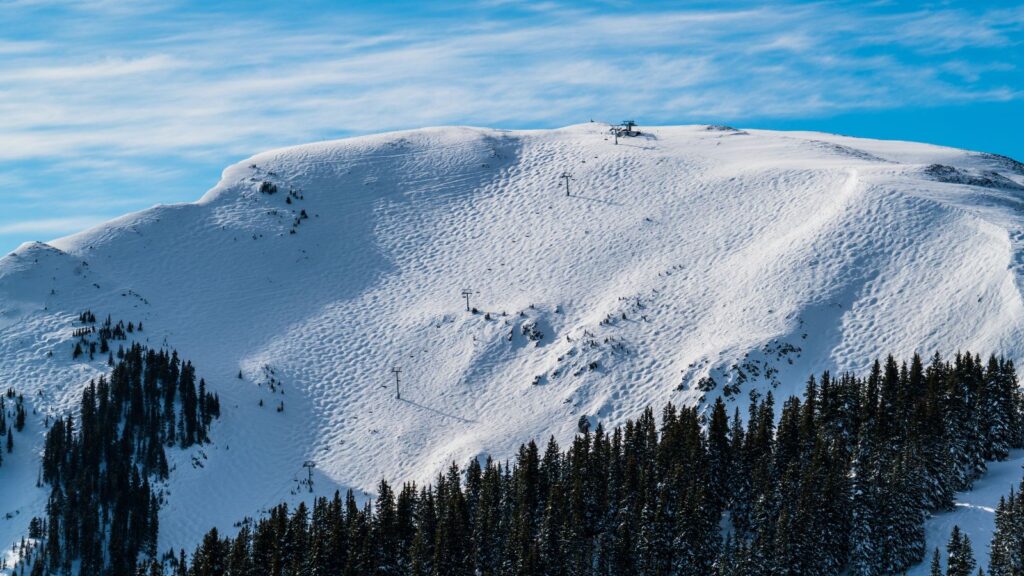 A bowl at Taos with a chair lift going down the middle.