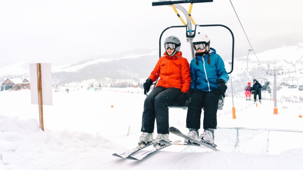 Two skiers on a chairlift together.