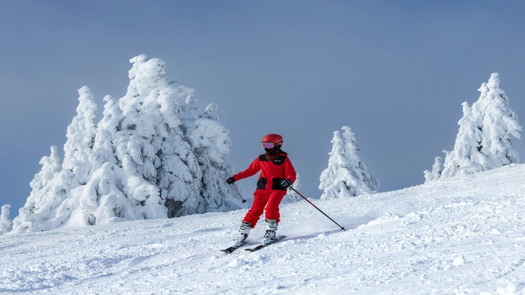 A skier dressed in red in Canada.