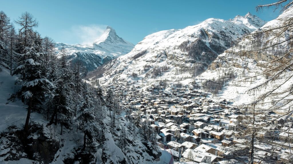 Zermatt surrounded by snow on a blue sky day.